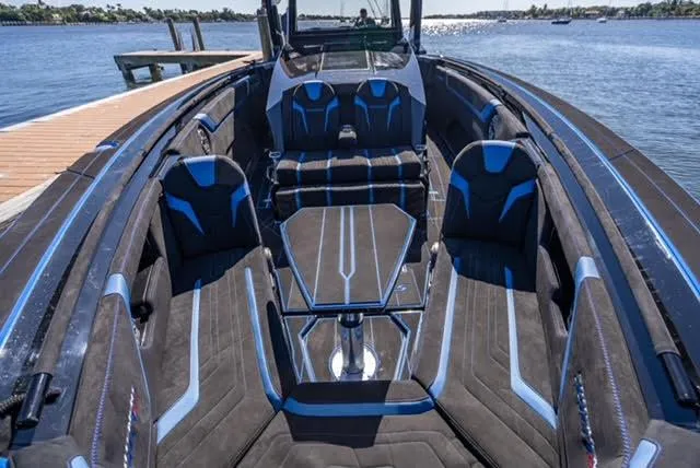 Slide: The Image of 2025 Statement 44 GTrs luxury boat interior with sleek black and blue seating. - 17