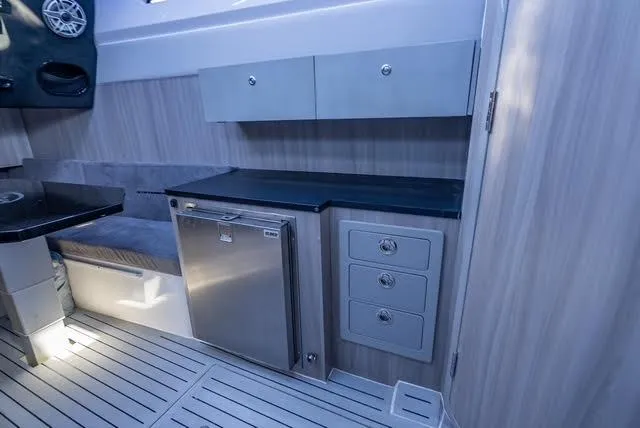 Slide: The Image of Modern yacht interior with sleek cabinetry, compact fridge, and stylish flooring in Statement 44 GTrs, 2025. - 19