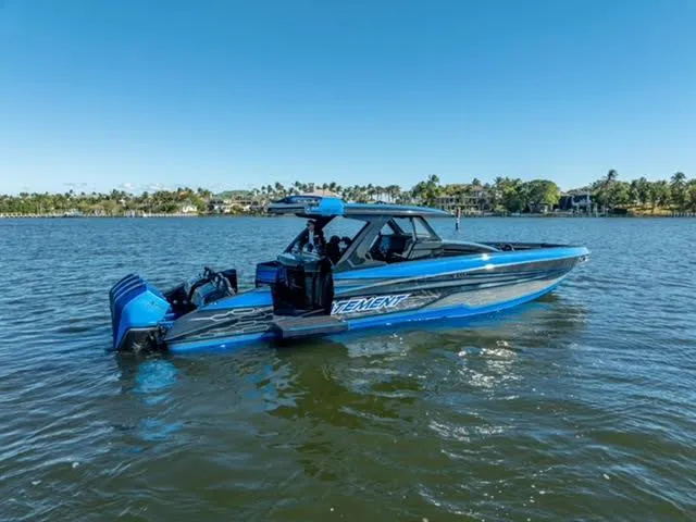 Slide: The Image of Blue 2025 Statement 44 GTrs boat on calm water, clear sky background. - 2