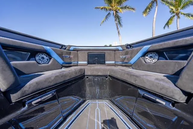 Slide: The Image of Luxurious interior of 2025 Statement 44 GTrs boat with sleek design and palm trees in background. - 24