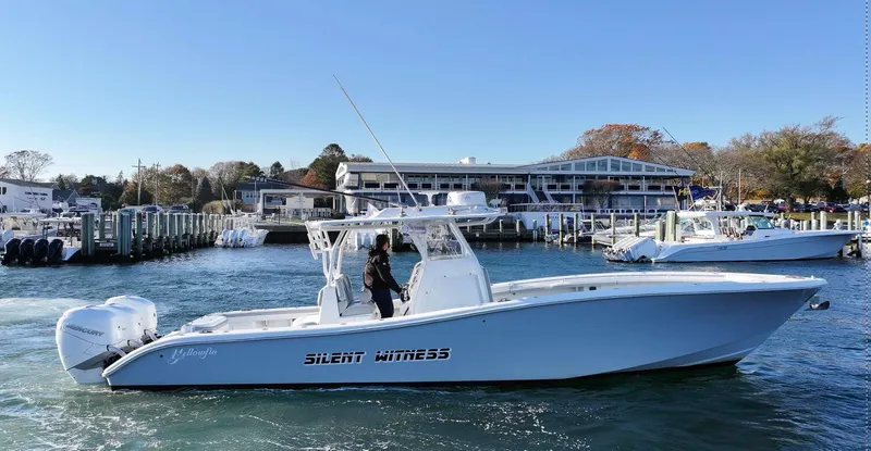 Slide: The Image of 2021 Yellowfin 36 Offshore boat on water near marina. - 1