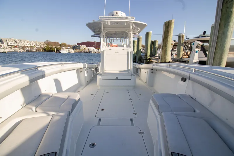 Slide: The Image of 2021 Yellowfin 36 Offshore boat docked, spacious deck, clear sky, waterfront view. - 4