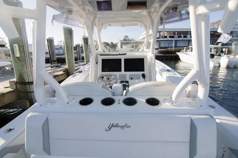 Slide: The Image of 2021 Yellowfin 36 Offshore boat at dock, featuring modern helm and spacious layout. - 5