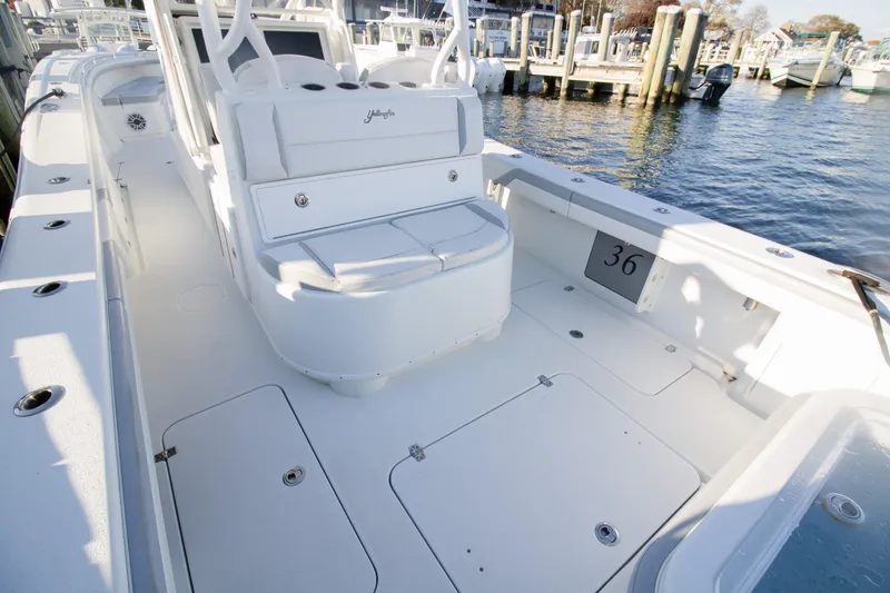 Slide: The Image of 2021 Yellowfin 36 Offshore boat interior with seating and storage, docked at marina. - 6