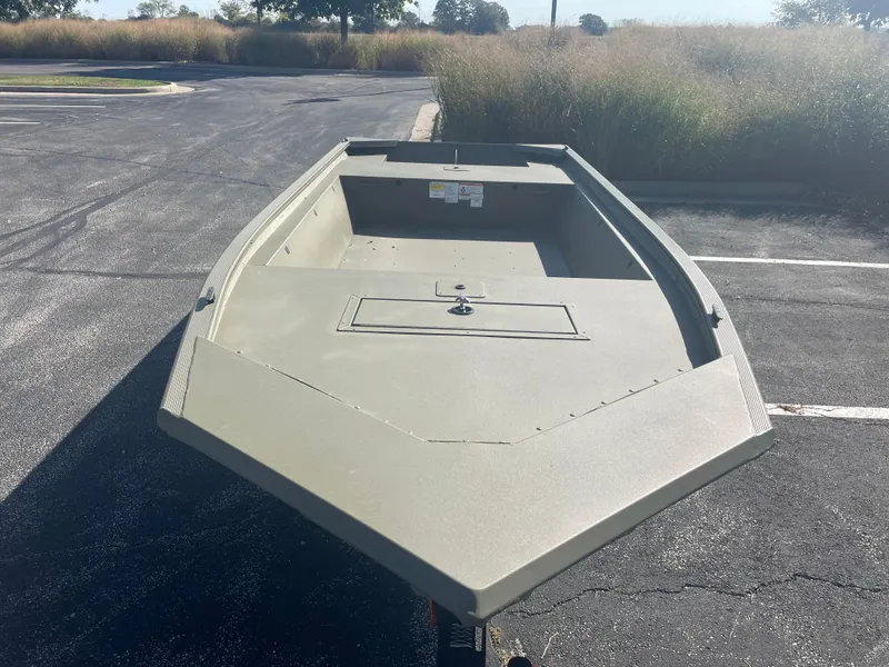 Slide: The Image of 2025 Tracker Grizzly 1648 Jon boat in a parking lot, front view. - 2