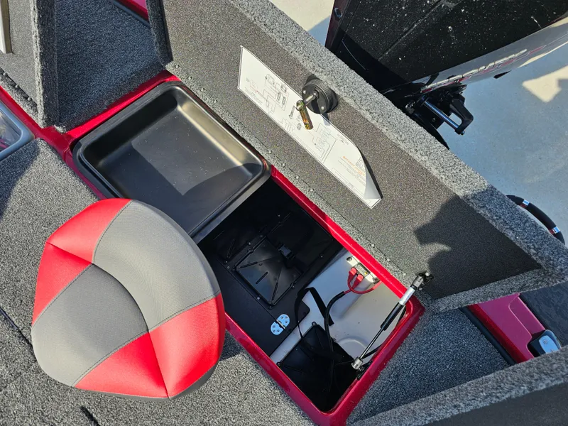 Slide: The Image of 2025 Nitro Z20 XL Pro boat storage compartment with red and gray seat. - 13