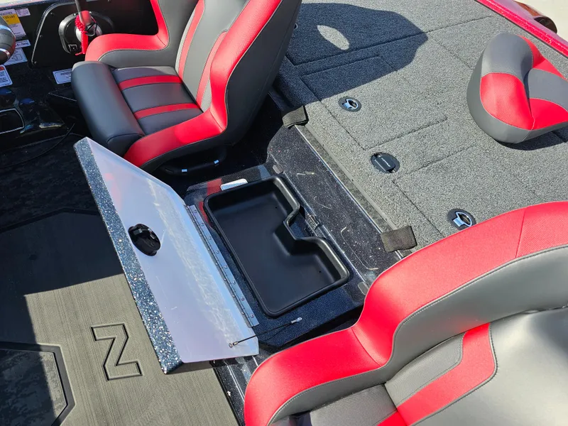 Slide: The Image of 2025 Nitro Z20 XL Pro boat interior with red and gray seats, open storage compartment. - 16