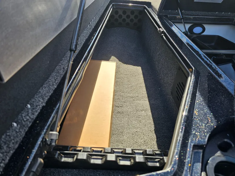 Slide: The Image of 2025 Nitro Z20 XL Pro boat storage compartment with carpeted interior. - 22