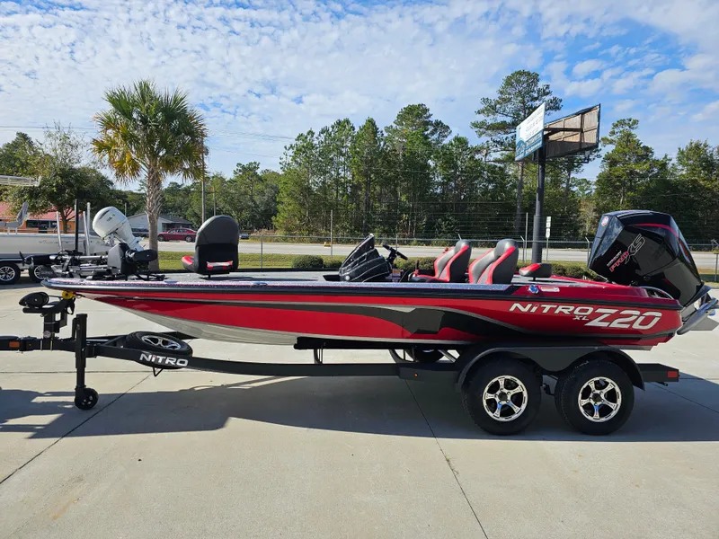 Slide: The Image of 2025 Nitro Z20 XL Pro bass boat on trailer, parked outdoors. - 6