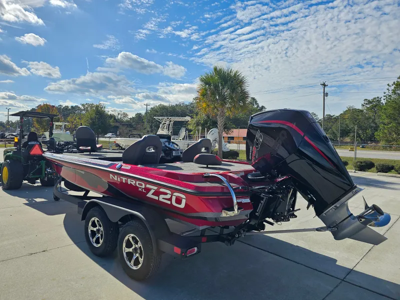 Slide: The Image of 2025 Nitro Z20 XL Pro boat on trailer, parked outdoors under a blue sky. - 7