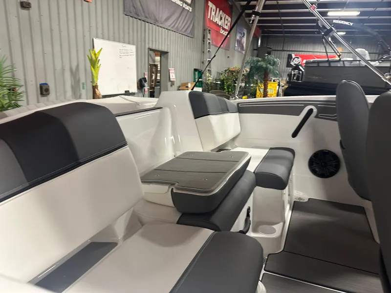 Slide: The Image of 2025 Tahoe T21 boat interior with sleek seating and modern design in showroom. - 10