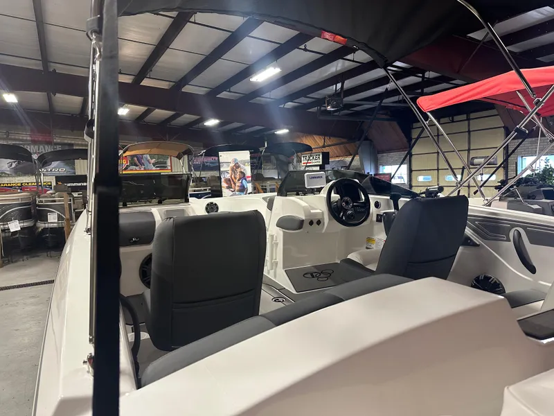 Slide: The Image of 2025 Tahoe T21 boat interior in showroom, featuring steering wheel and seating. - 3