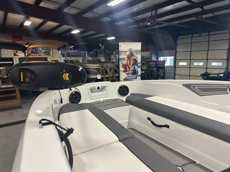 Slide: The Image of 2025 Tahoe T21 boat interior in showroom, featuring sleek seating and modern design. - 4