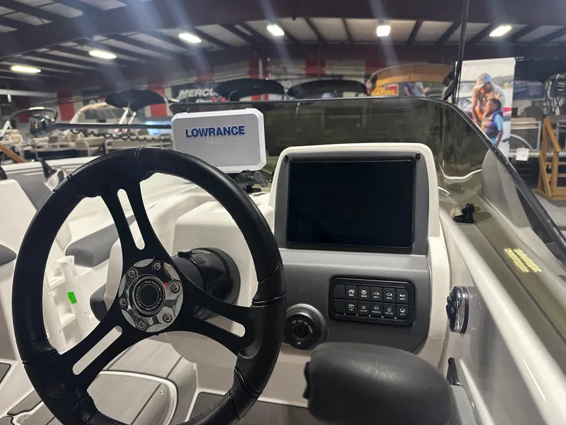 Slide: The Image of 2025 Tahoe T21 boat dashboard with steering wheel and Lowrance navigation system. - 7