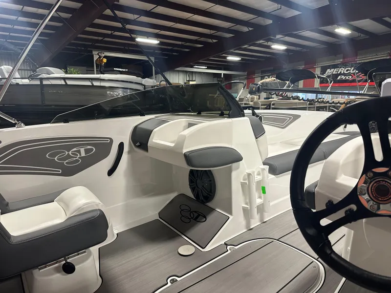 Slide: The Image of 2025 Tahoe T21 boat interior with sleek seating and modern design in a showroom. - 8