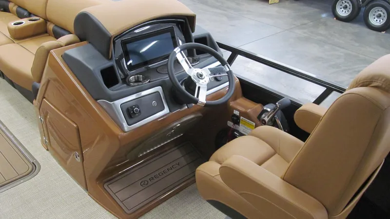 Slide: The Image of 2025 Regency 250 LE3 Sport boat interior with tan leather seats and modern dashboard. - 11