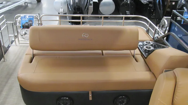 Slide: The Image of 2025 Regency 250 LE3 Sport boat interior with tan seating and control panel. - 12