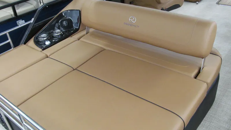 Slide: The Image of 2025 Regency 250 LE3 Sport boat with tan leather seating and control panel. - 15