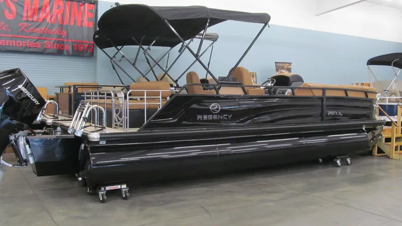 Slide: The Image of 2025 Regency 250 LE3 Sport pontoon boat displayed indoors. - 3