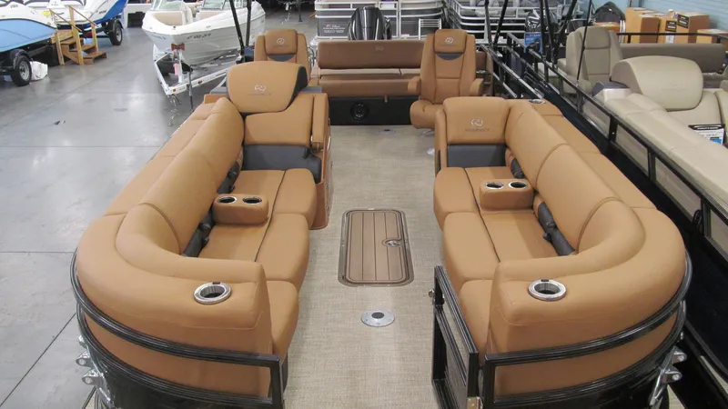 Slide: The Image of 2025 Regency 250 LE3 Sport pontoon boat with luxurious tan seating and cup holders. - 5