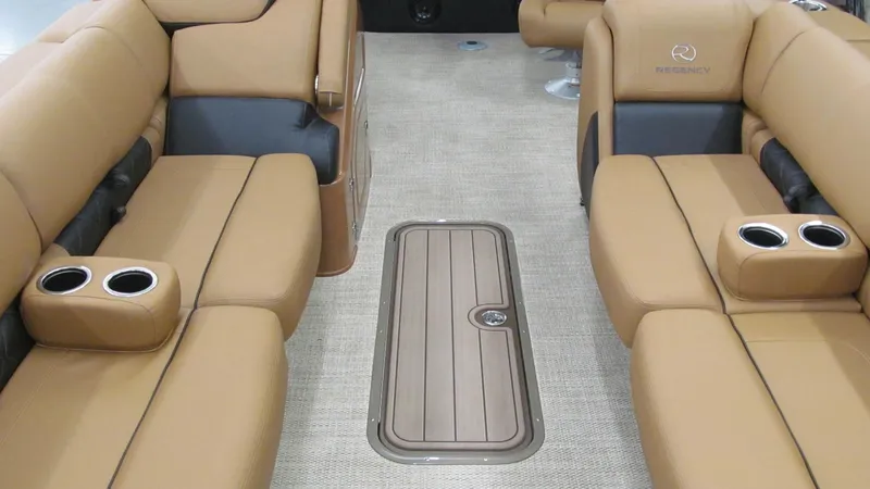 Slide: The Image of Luxurious interior of 2025 Regency 250 LE3 Sport boat with tan seating and cup holders. - 7