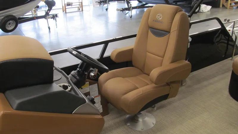 Slide: The Image of 2025 Regency 250 LE3 Sport boat interior with luxurious captain's chair and steering console. - 9