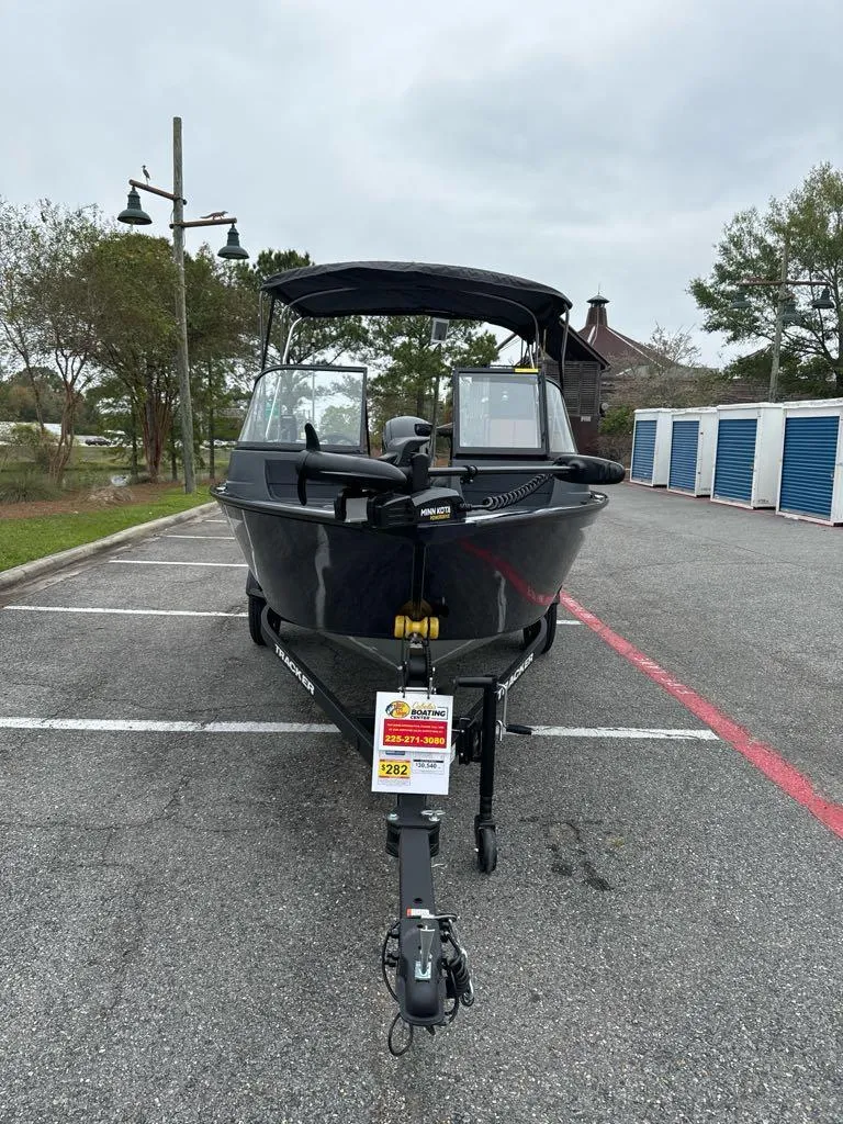 Slide: The Image of 2025 Tracker Pro Guide V-16 WT boat parked outdoors. - 3