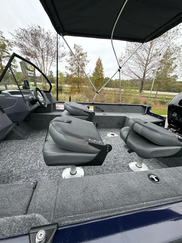Slide: The Image of 2025 Tracker Pro Guide V-16 WT boat interior with seating and canopy. - 4