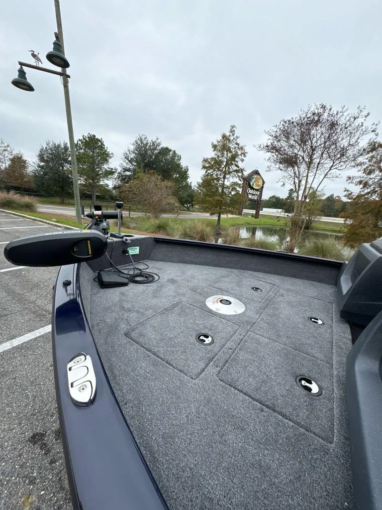 Slide: The Image of 2025 Tracker Pro Guide V-16 WT boat deck in a scenic outdoor setting. - 7