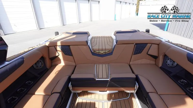 Slide: The Image of 2025 Nautique Super Air Nautique S23 interior with tan seating and wood accents. - 16