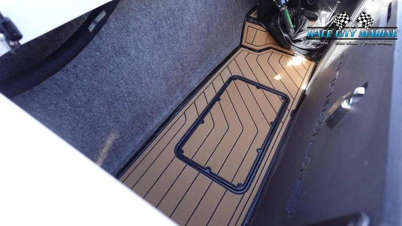 Slide: The Image of 2025 Nautique Super Air Nautique S23 storage compartment with custom flooring. - 19