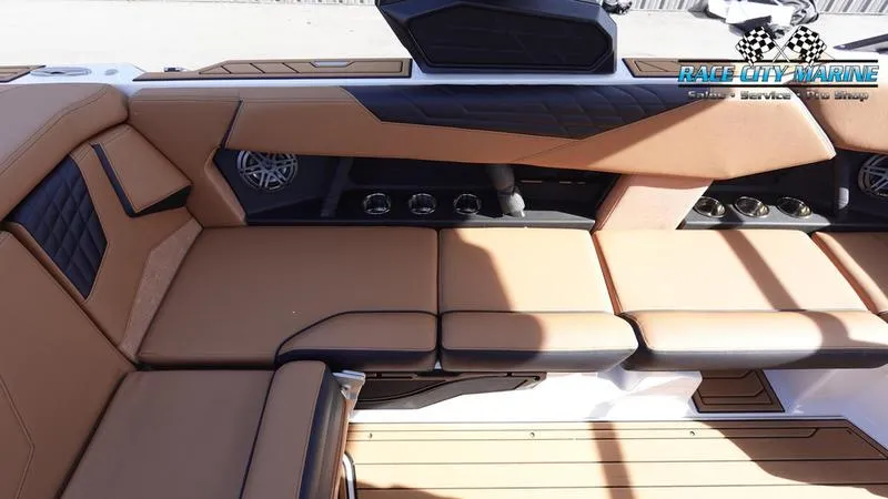 Slide: The Image of 2025 Nautique Super Air Nautique S23 interior with tan seating and modern design. - 23