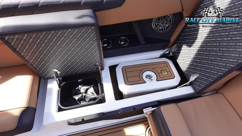 Slide: The Image of 2025 Nautique Super Air Nautique S23 interior storage compartments and seating detail. - 26