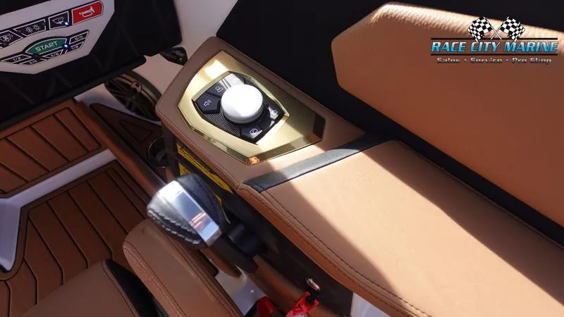 Slide: The Image of 2025 Nautique Super Air Nautique S23 interior with control panel and tan seating. - 32