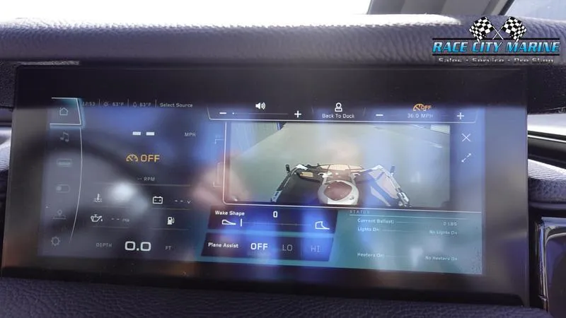 Slide: The Image of 2025 Nautique Super Air Nautique S23 dashboard display with rearview camera and controls. - 35