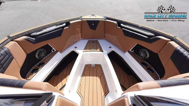 Slide: The Image of 2025 Nautique Super Air Nautique S23 boat interior with tan and black seating. - 43