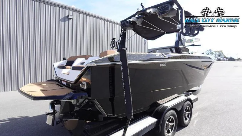 Slide: The Image of 2025 Nautique Super Air Nautique S23 boat on trailer, Race City Marine logo visible. - 8