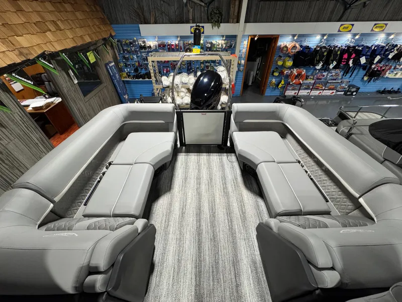 Slide: The Image of 2025 Bennington 22 MFB pontoon boat interior with gray seating in a showroom. - 9
