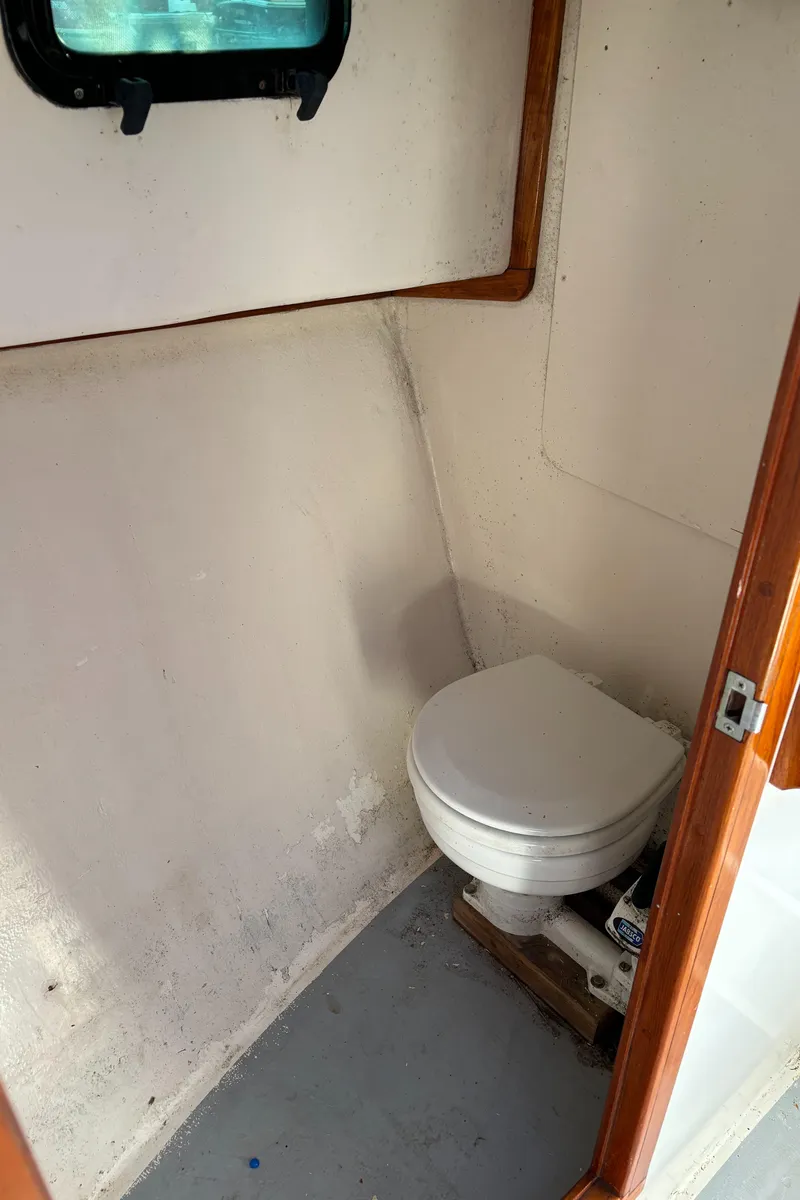 Slide: The Image of 1992 Duffy 26' boat interior with compact marine toilet. - 12