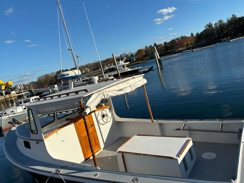 Slide: The Image of 1992 Duffy 26' boat docked in a serene marina under a clear blue sky. - 4