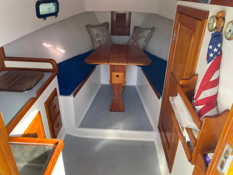 Slide: The Image of Interior of a 1992 Duffy 26' boat with wooden table and seating area. - 5