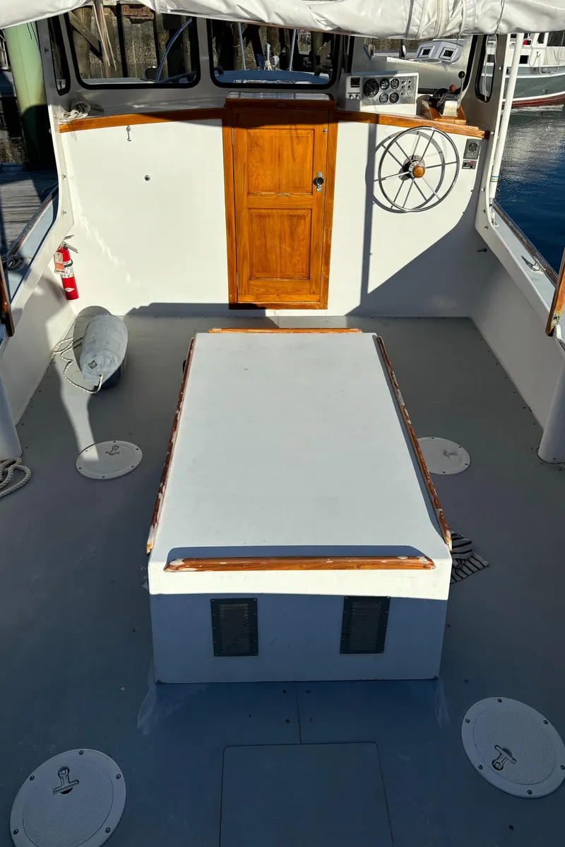 Slide: The Image of 1992 Duffy 26' boat interior with wooden door and steering wheel. - 9