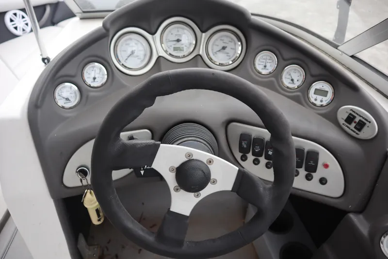 Slide: The Image of Steering wheel and dashboard of 2006 Moomba Outback LSV boat with gauges and controls. - 8