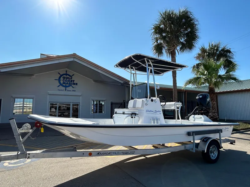 The Image of 2025 Shallow Stalker Cat 204 boat on trailer, parked outside a marine store. - 0