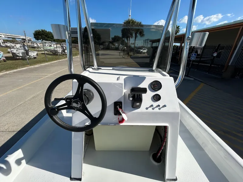 Slide: The Image of Shallow Stalker Cat 204 boat console, 2025 model, with steering wheel and controls. - 12