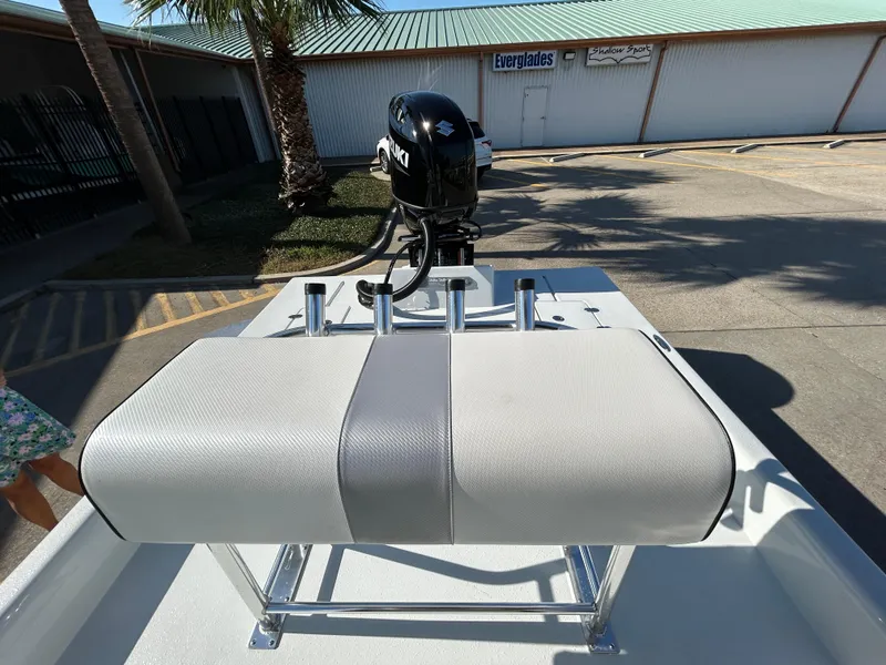 Slide: The Image of Shallow Stalker Cat 204 boat, 2025 model, with motor and seating, parked outdoors. - 15