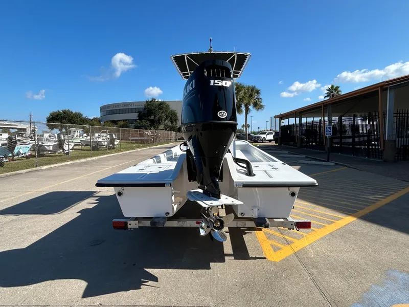 Slide: The Image of 2025 Shallow Stalker Cat 204 boat with 150 HP engine, parked outdoors. - 6