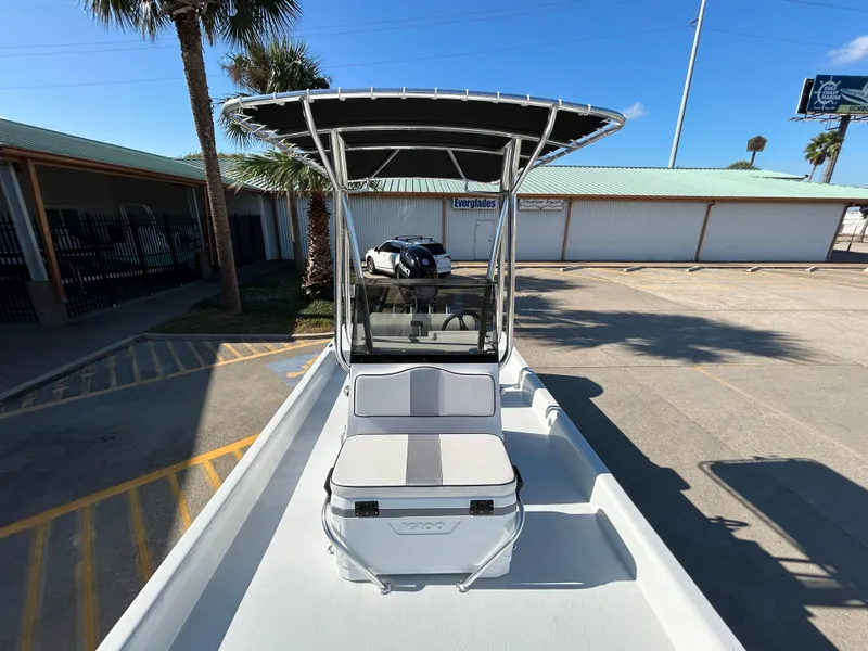 Slide: The Image of 2025 Shallow Stalker Cat 204 boat with T-top in a sunny parking lot. - 7