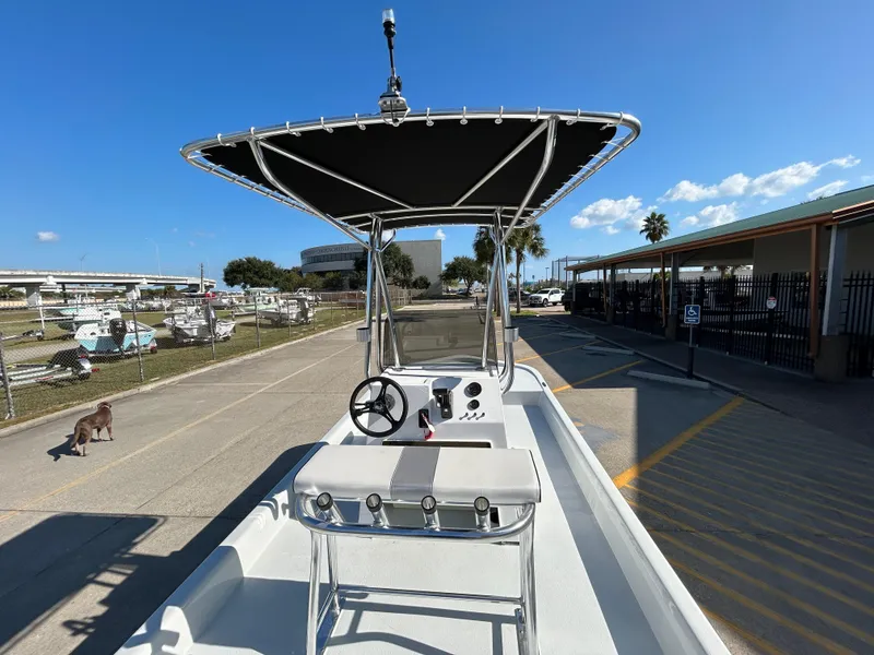 Slide: The Image of 2025 Shallow Stalker Cat 204 boat with T-top, parked in sunny marina. - 8