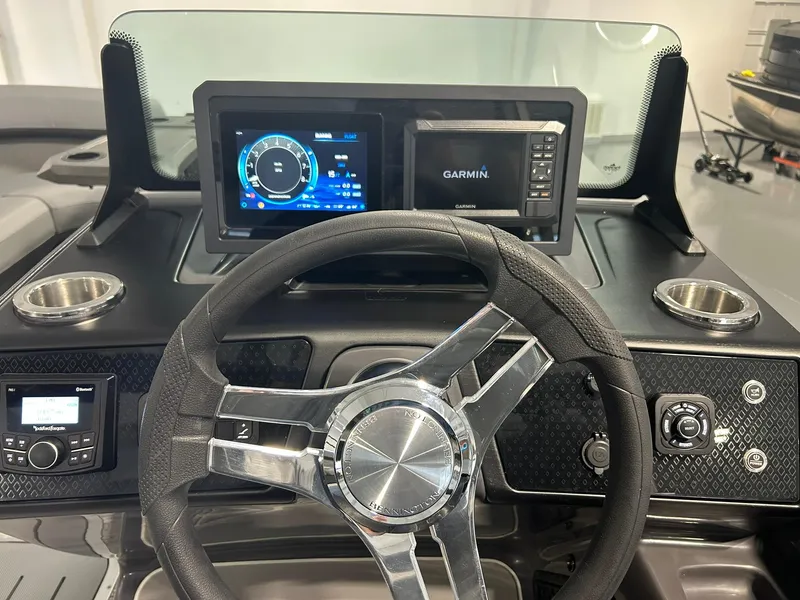 Slide: The Image of 2025 Bennington 22 MSB dashboard with steering wheel and Garmin display. - 13